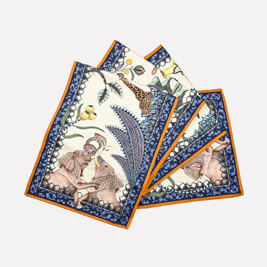 A set of Ardmore's Sabie Forest Table Runners in a deep Tanzanite blue colour palette, featuring intricate wildlife and botanical patterns.