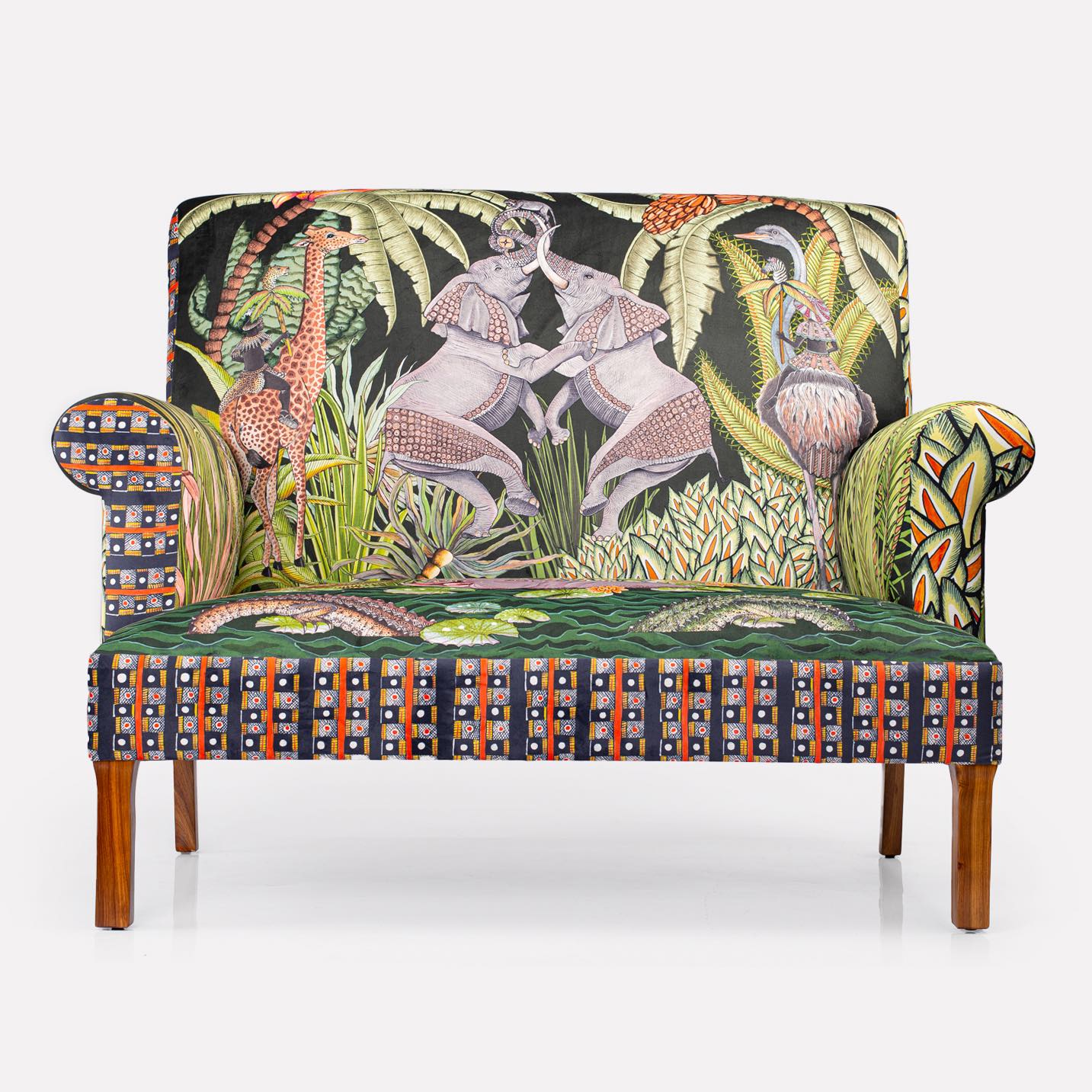 Close-up of the sofa’s backrest, highlighting the depth and texture of the velvet fabric adorned with vibrant foliage.
