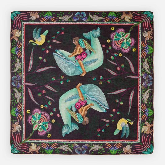 A limited-edition wool and modal wrap featuring a celestial-inspired design with soft blue birds, golden chains, and vibrant floral elements against a deep midnight background.