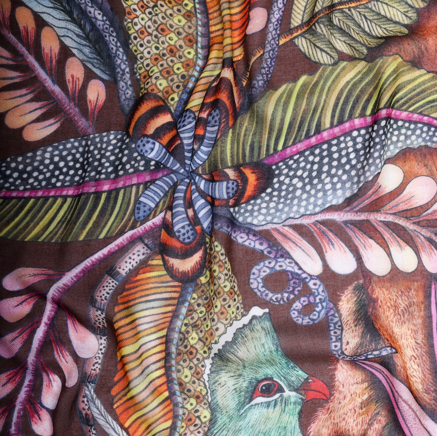 A detailed section highlighting the rich botanical patterns, including woven vines and exotic plants.