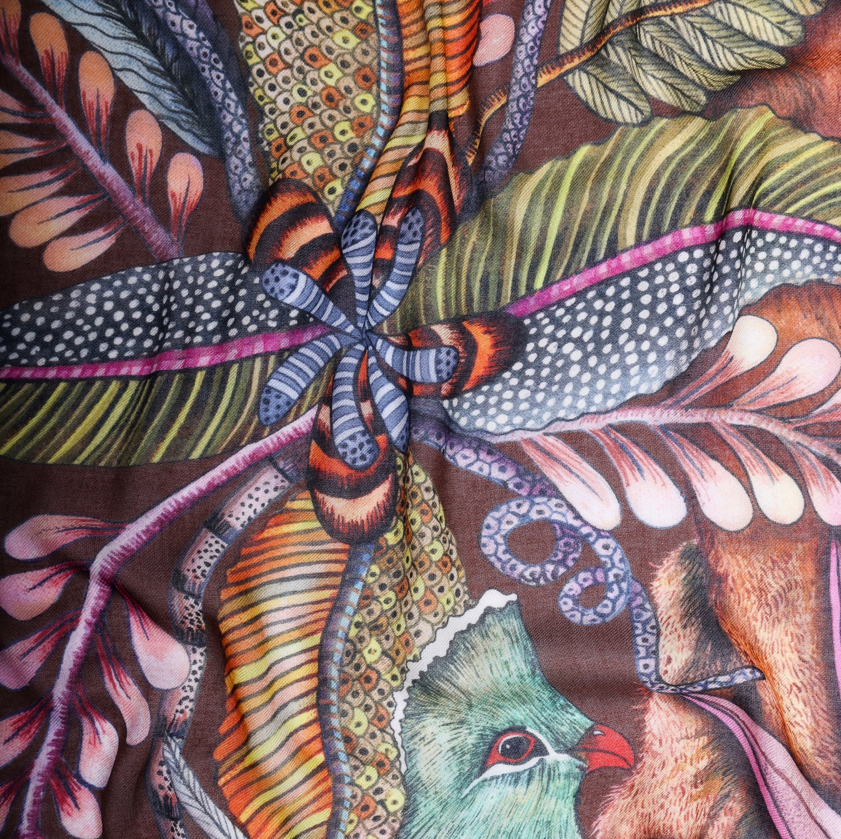 A detailed section highlighting the rich botanical patterns, including woven vines and exotic plants.