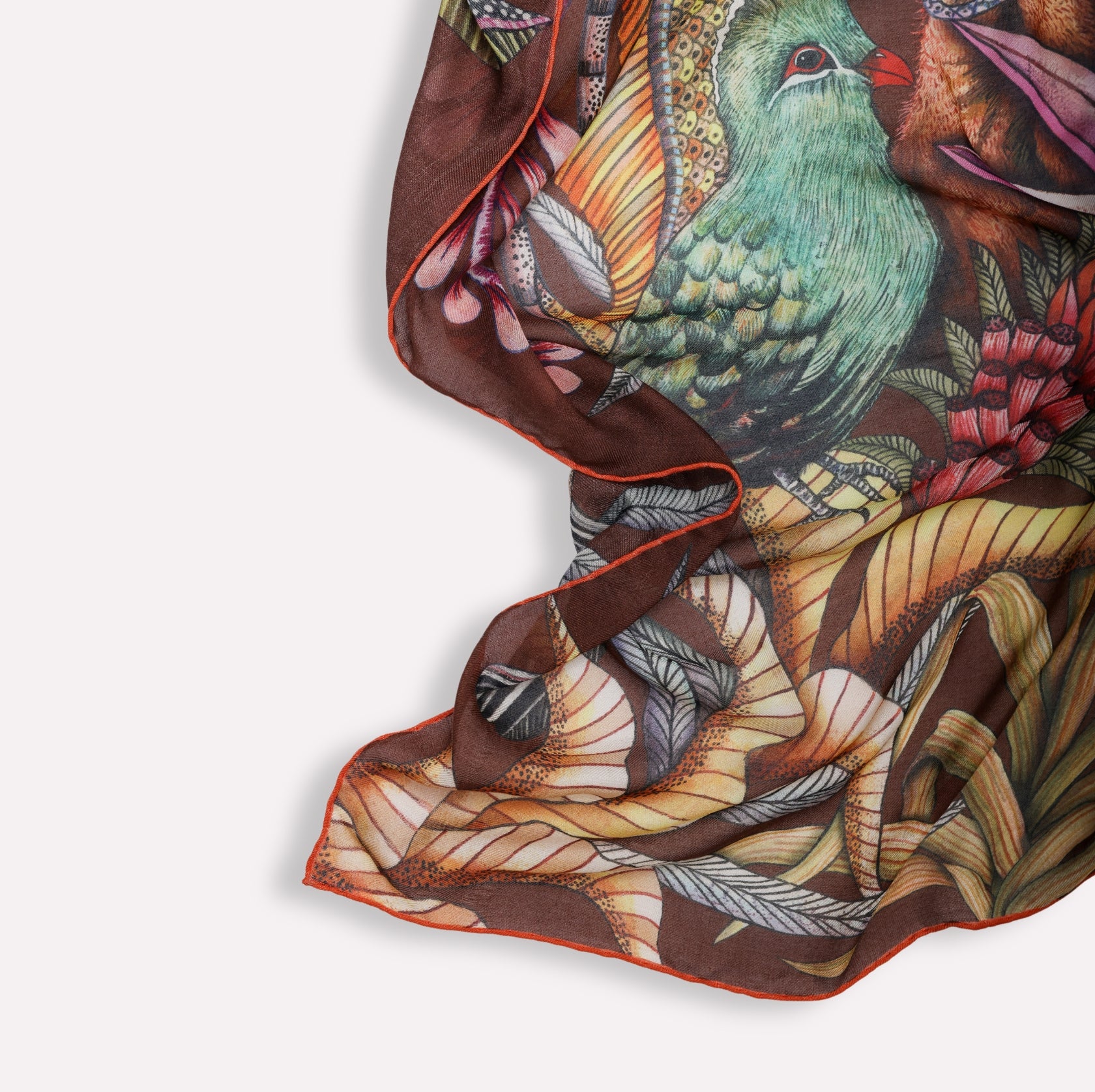 A styled shot of the scarf’s edge, revealing the soft hand-rolled hem and how the colours layer when folded.