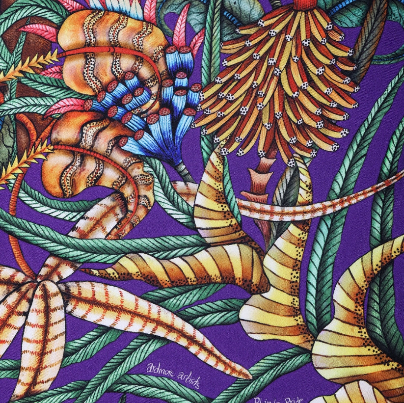 A detailed section of the scarf showcasing exotic flowers and jungle foliage with striking colour contrasts.