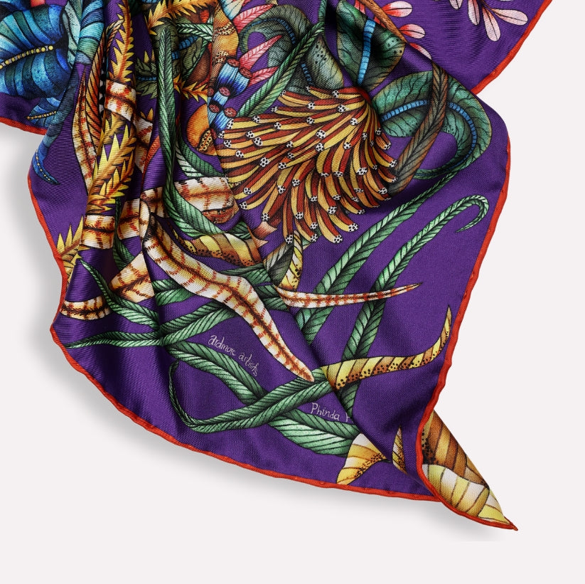 A shot of the scarf elegantly draped, emphasising the luxurious silk fabric and the fluidity of the design when worn.