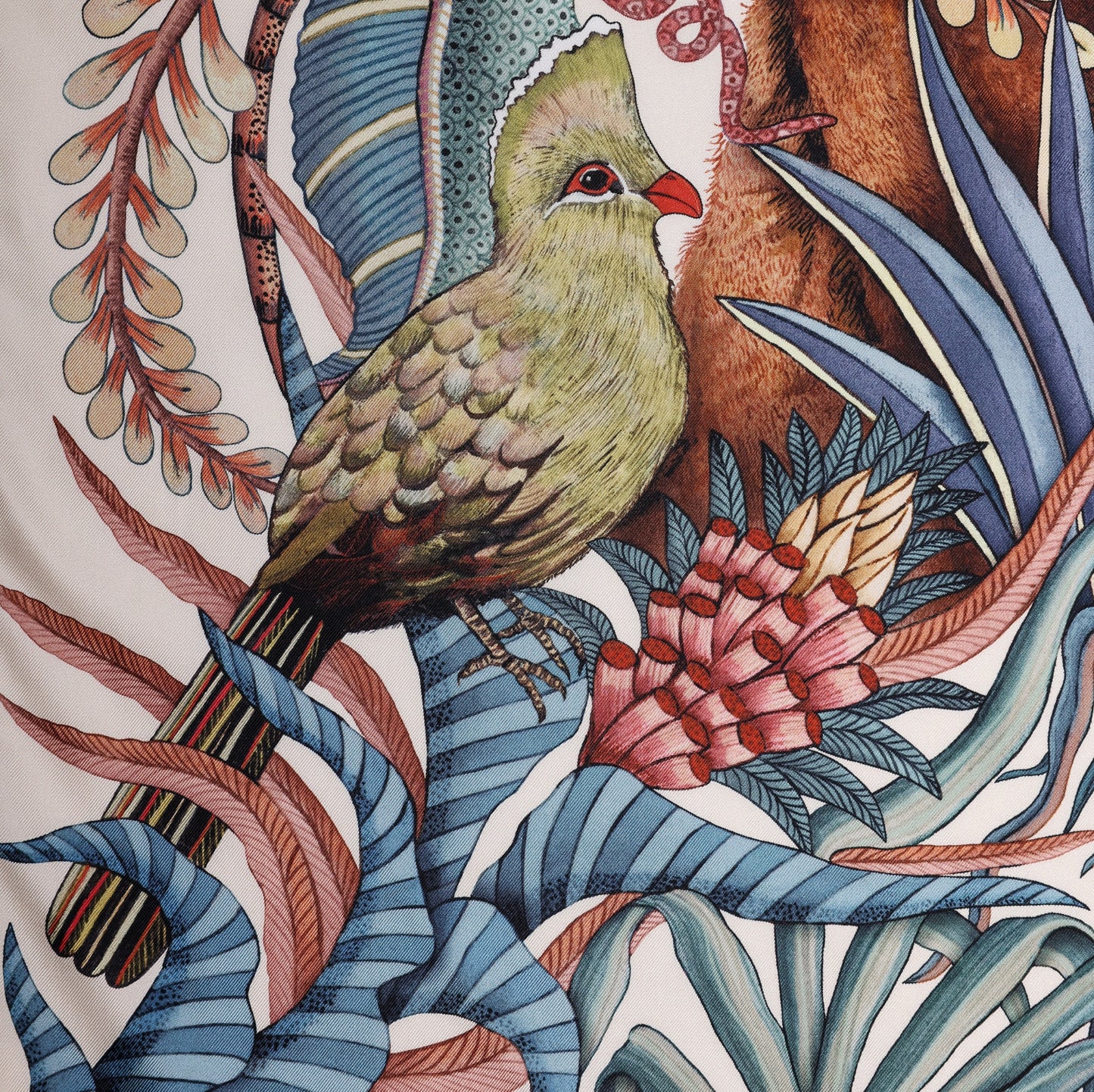 A close-up of a vibrant green turaco bird perched among the tropical flora, adding an exotic touch to the scarf.