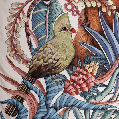 A zoomed-in section highlighting a beautifully painted green loerie bird perched among delicate branches and foliage.