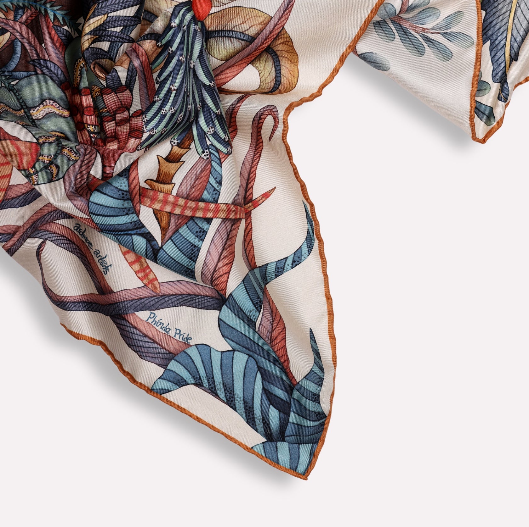  A shot of the scarf elegantly folded, emphasising the luxurious texture of the silk and the intricate pattern flow.