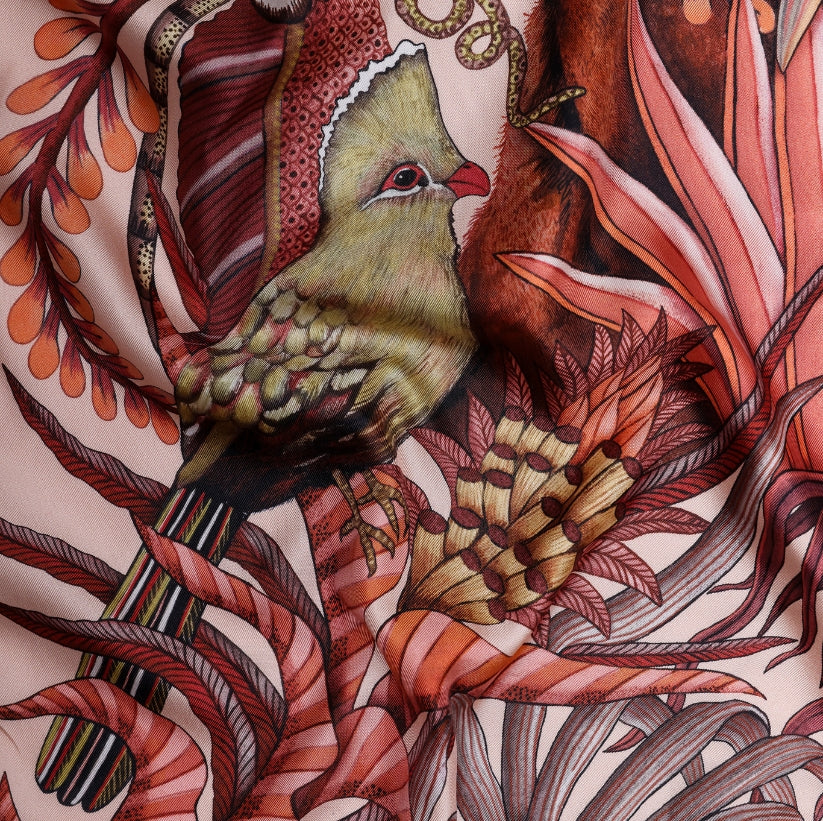 A close-up of a green turaco bird among detailed floral and foliage patterns, adding an exotic touch to the composition.