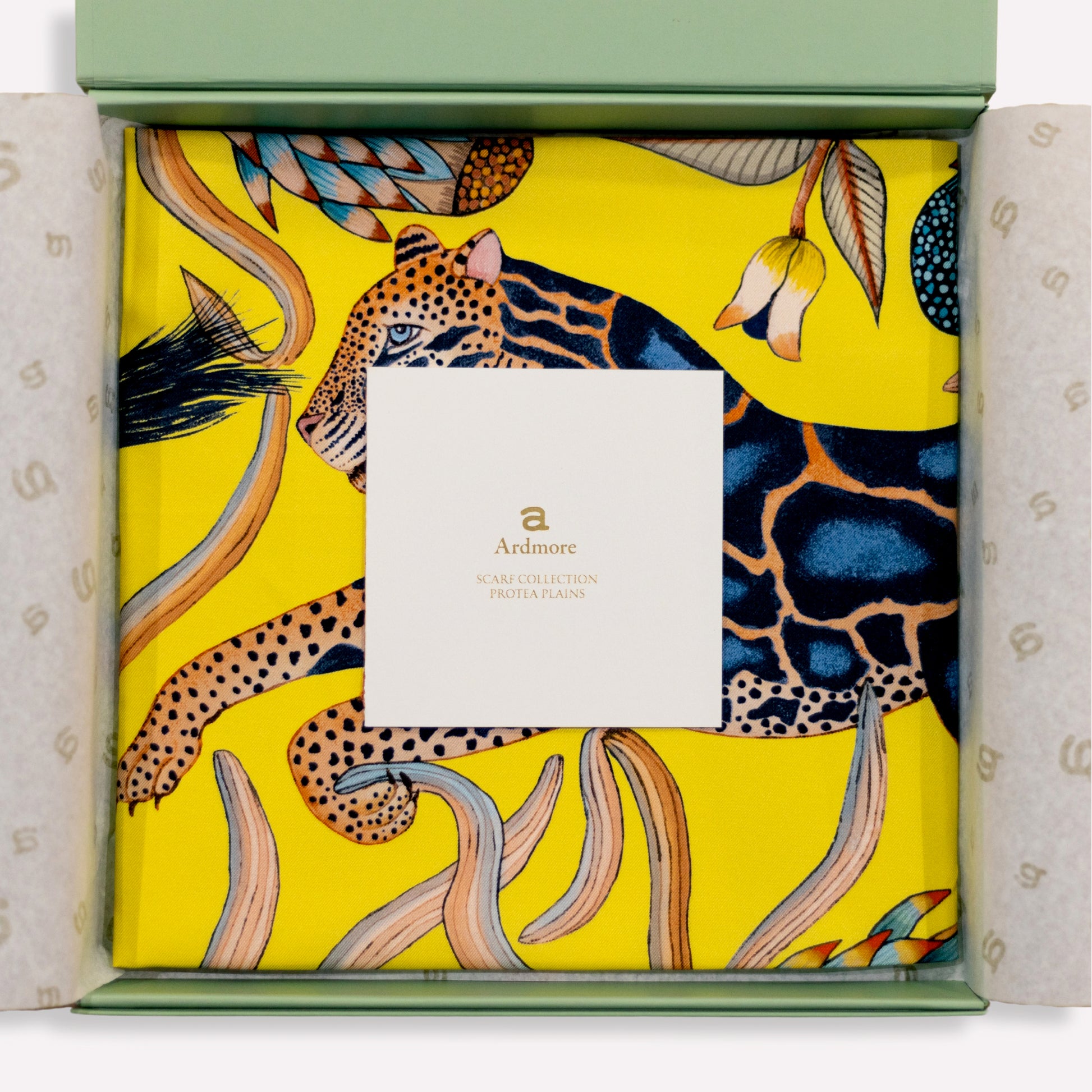 The scarf elegantly folded inside premium packaging, sealed with an official Ardmore Design label for an exquisite presentation.