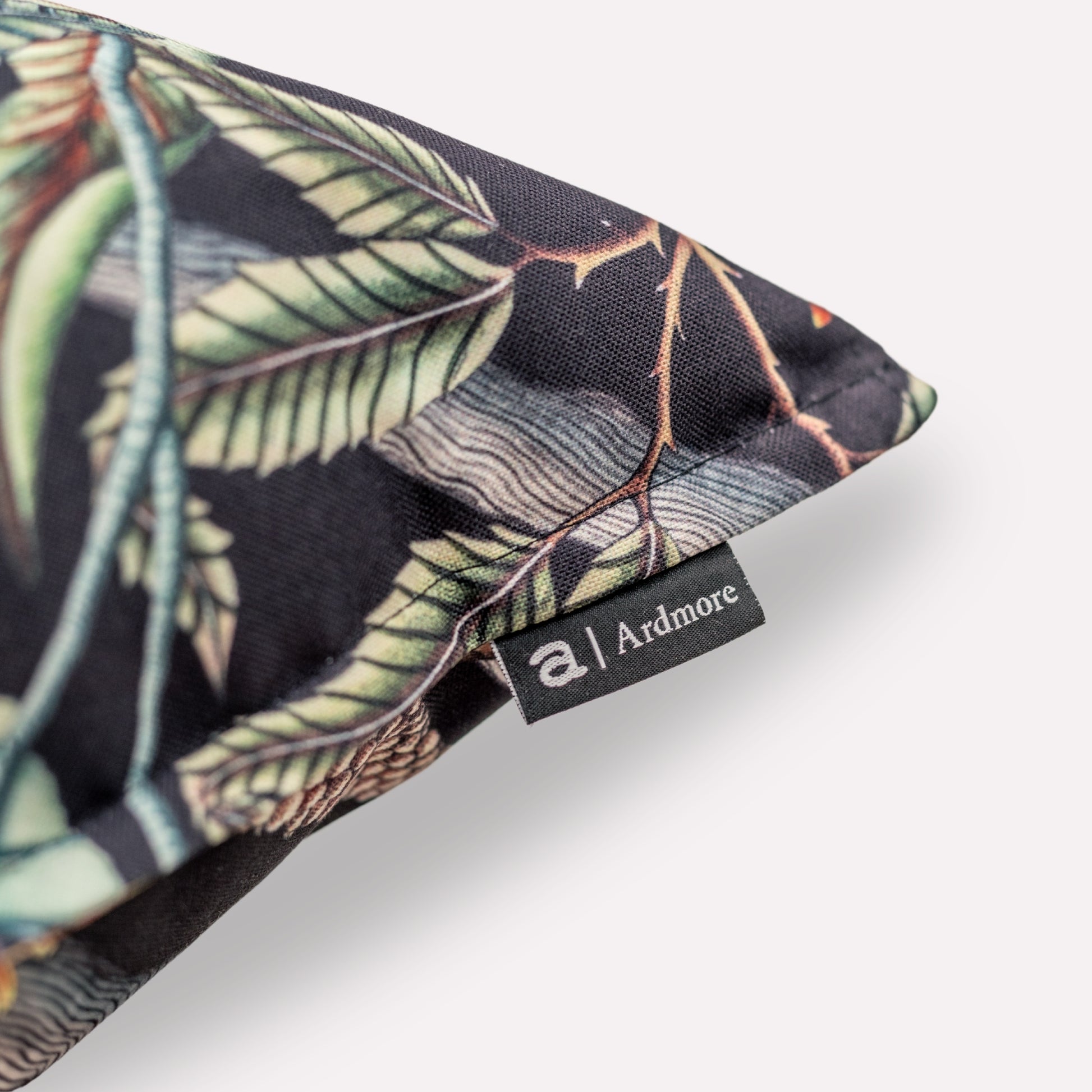 Close-up of the fabric corner and piping detail of the Pangolin Park Night Outdoor Cushion Cover, demonstrating its high-quality polyester material and durable stitching.