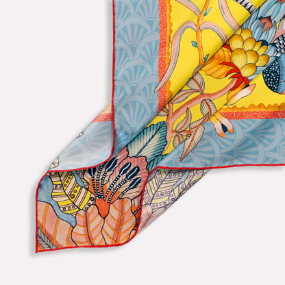 A folded section emphasising the depth of the print, the silk's natural sheen, and the layering of vivid colours.
