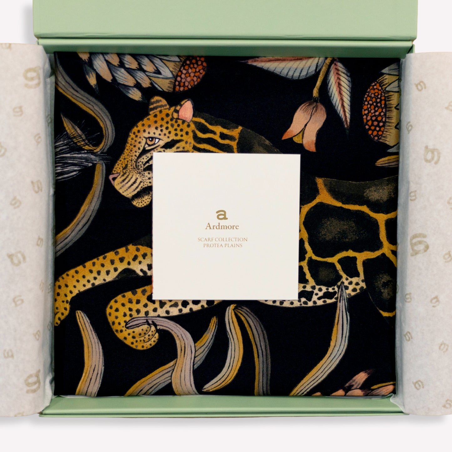 A carefully draped display capturing the scarf’s soft sheen and fluid silk quality, enhancing its opulent appeal.