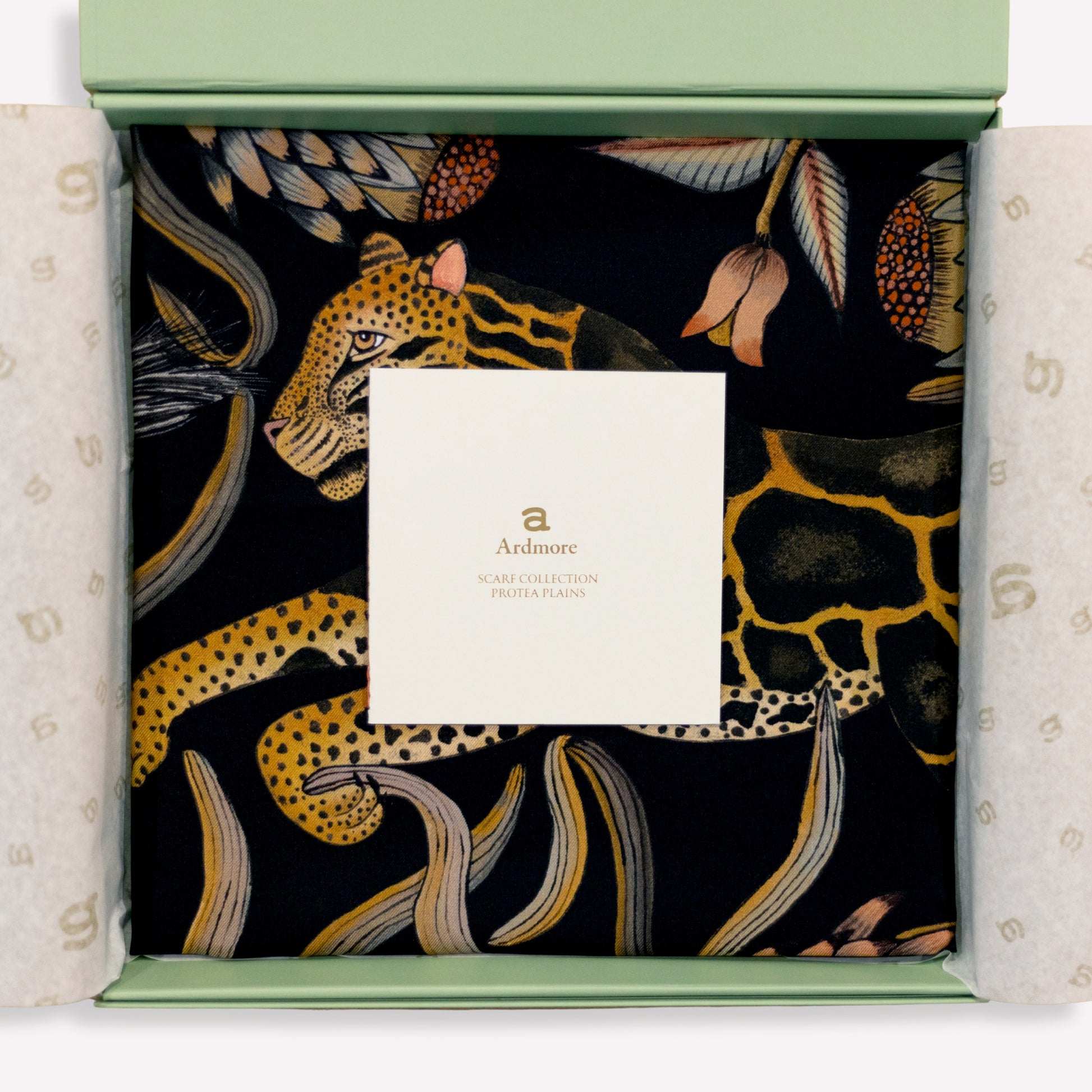 A carefully draped display capturing the scarf’s soft sheen and fluid silk quality, enhancing its opulent appeal.