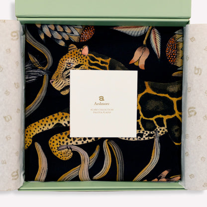 A carefully draped display capturing the scarf’s soft sheen and fluid silk quality, enhancing its opulent appeal.