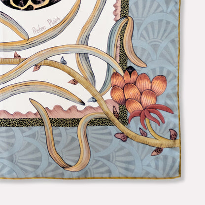 A close-up of the scarf’s muted colour palette, featuring subtle layering of florals, wildlife, and geometric elements for a sophisticated aesthetic.