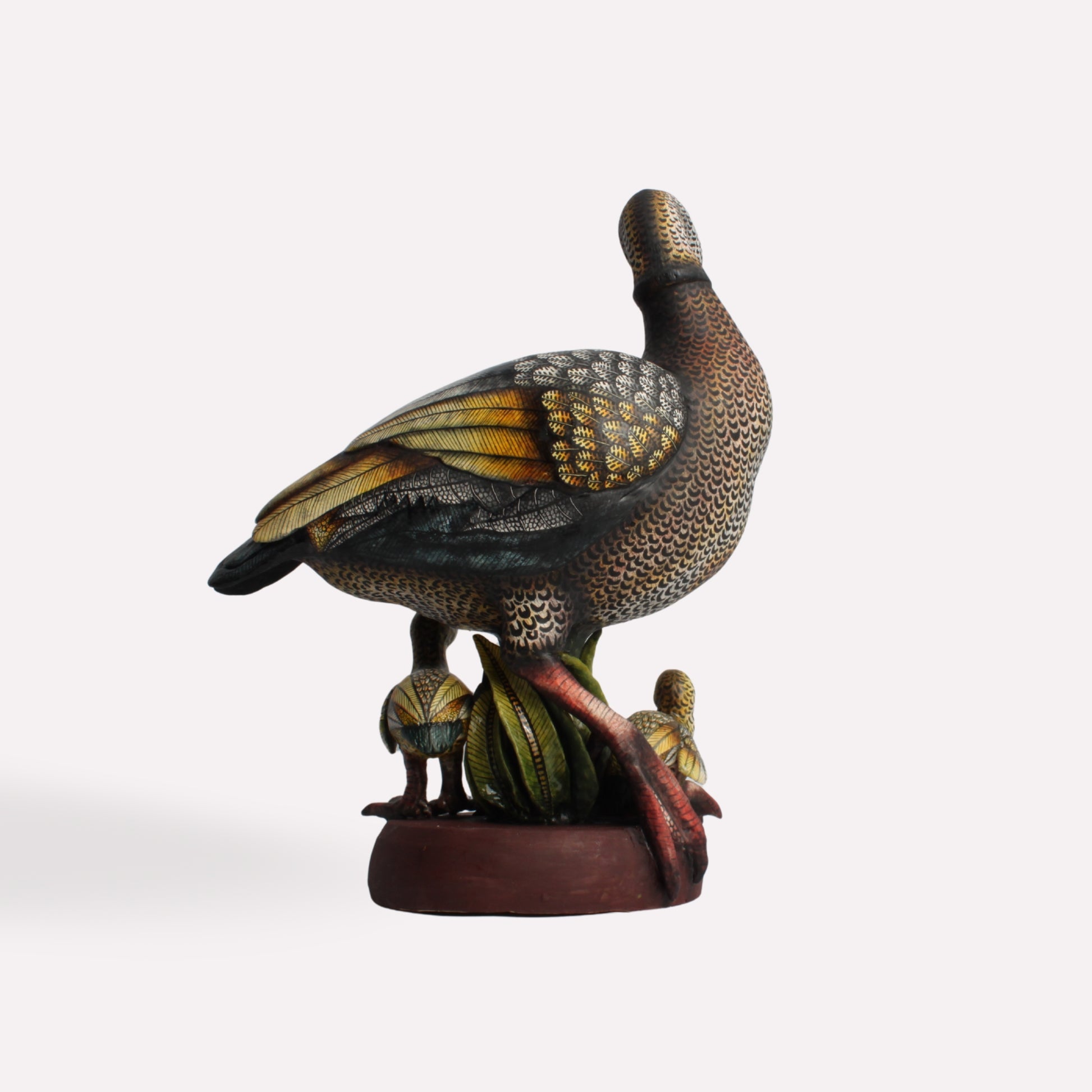  A side-angle perspective showing the sculpture’s depth and the interaction between the mother goose and her young. The hand-painted details on the wings and body highlight the texture and movement of the piece.