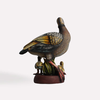  A side-angle perspective showing the sculpture’s depth and the interaction between the mother goose and her young. The hand-painted details on the wings and body highlight the texture and movement of the piece.