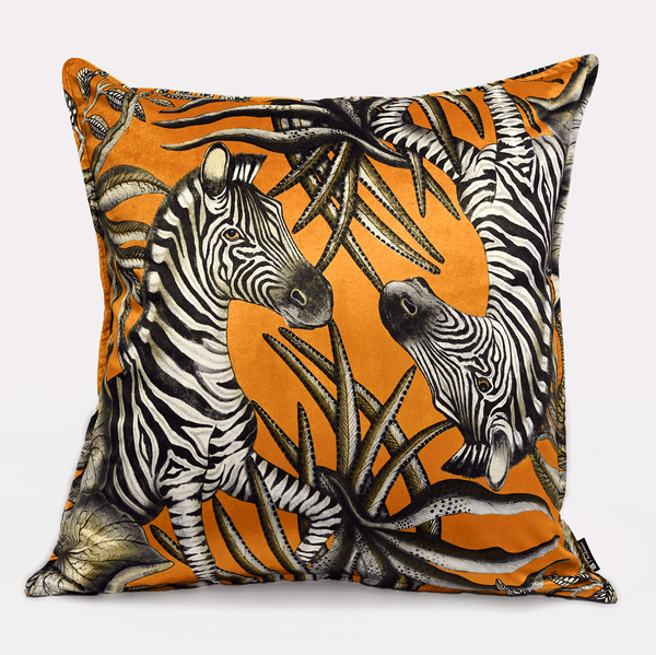 Front view of the Thanda Stripe Flame Velvet Cushion Cover, featuring a striking zebra motif set against a vibrant orange background, accented with lush African-inspired foliage.