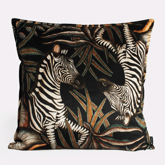Front view of the Thanda Stripe Night Velvet Cushion Cover featuring a striking zebra design amidst dark foliage, crafted on luxurious velvet fabric.