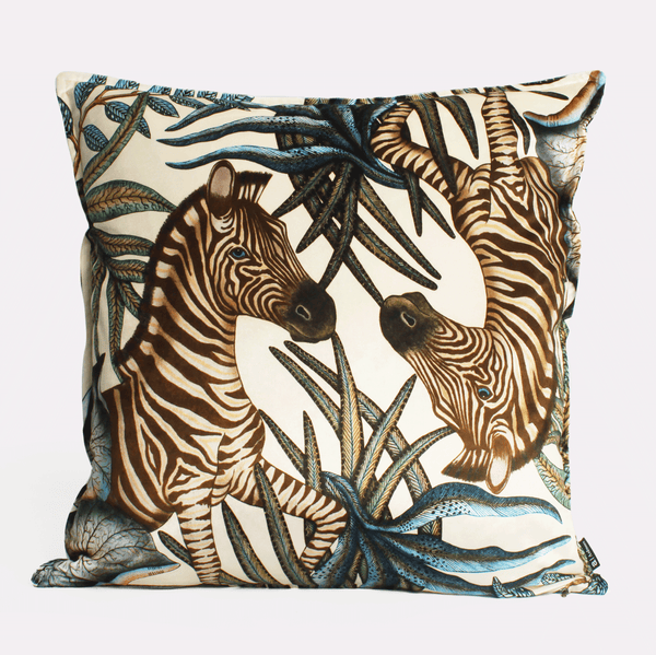 Front view of the Thanda Stripe Tanzanite Velvet Cushion Cover, showcasing majestic zebras amidst lush greenery on luxurious velvet fabric.