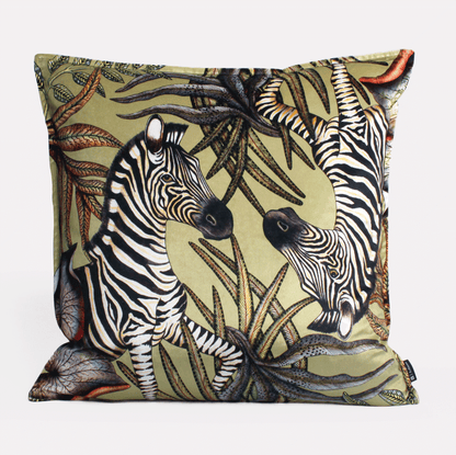 Front view of the Thanda Stripe Delta Velvet Cushion Cover, highlighting an intricate zebra design set amidst lush greenery on premium velvet.