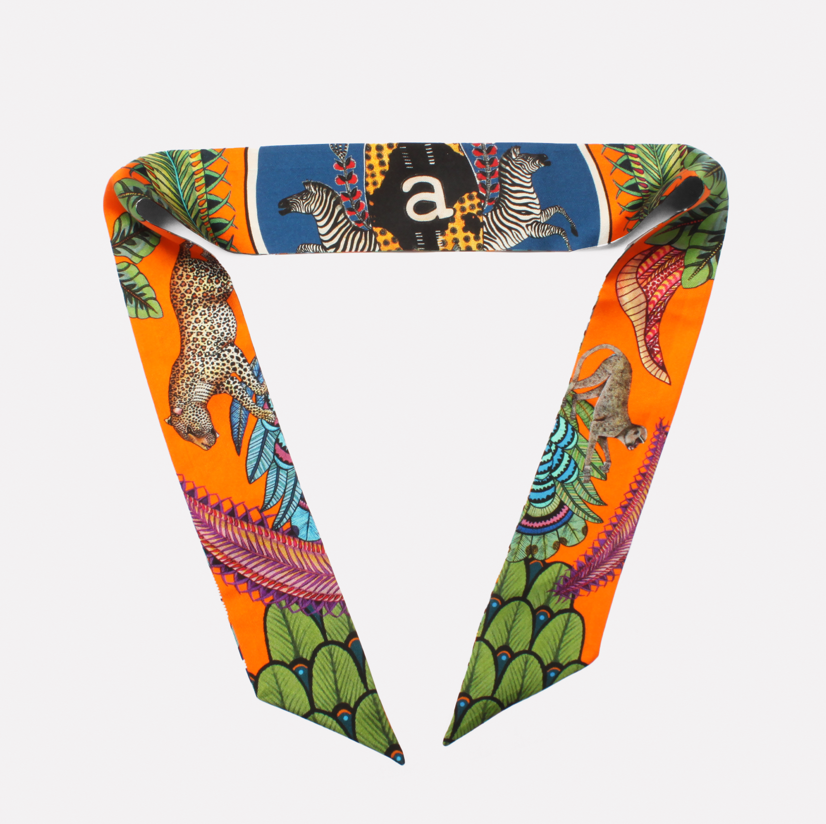A close-up of the silk twill accessory tied in a neat loop, showcasing its striking colours and intricate design, perfect for versatile styling.