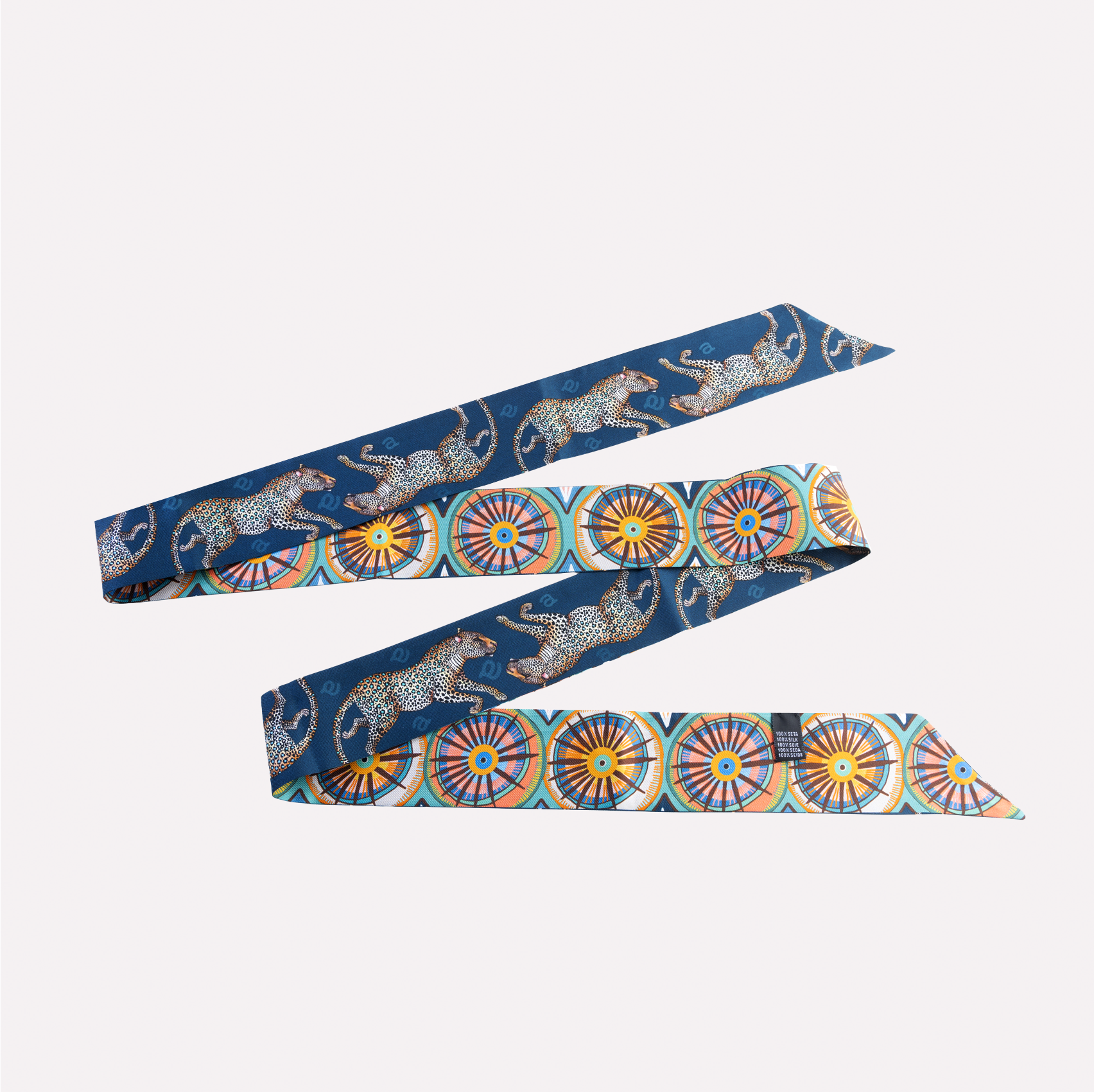 A long, double-sided silk twilly featuring intricate Amasumpa African prints and leopards against a rich tanzanite blue background.