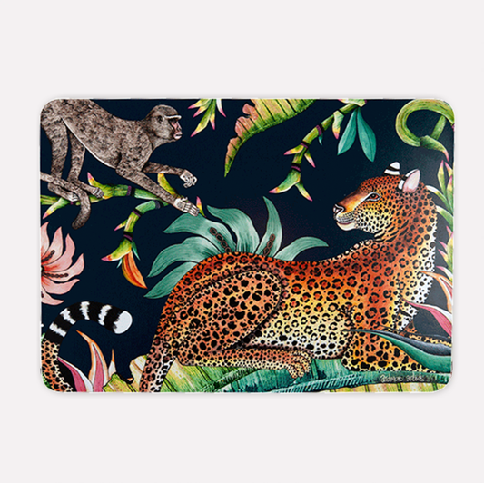 A hardboard placemat featuring a striking design of a golden-hued leopard lounging in lush tropical foliage, with a playful monkey above, set against a deep moonlight blue background.