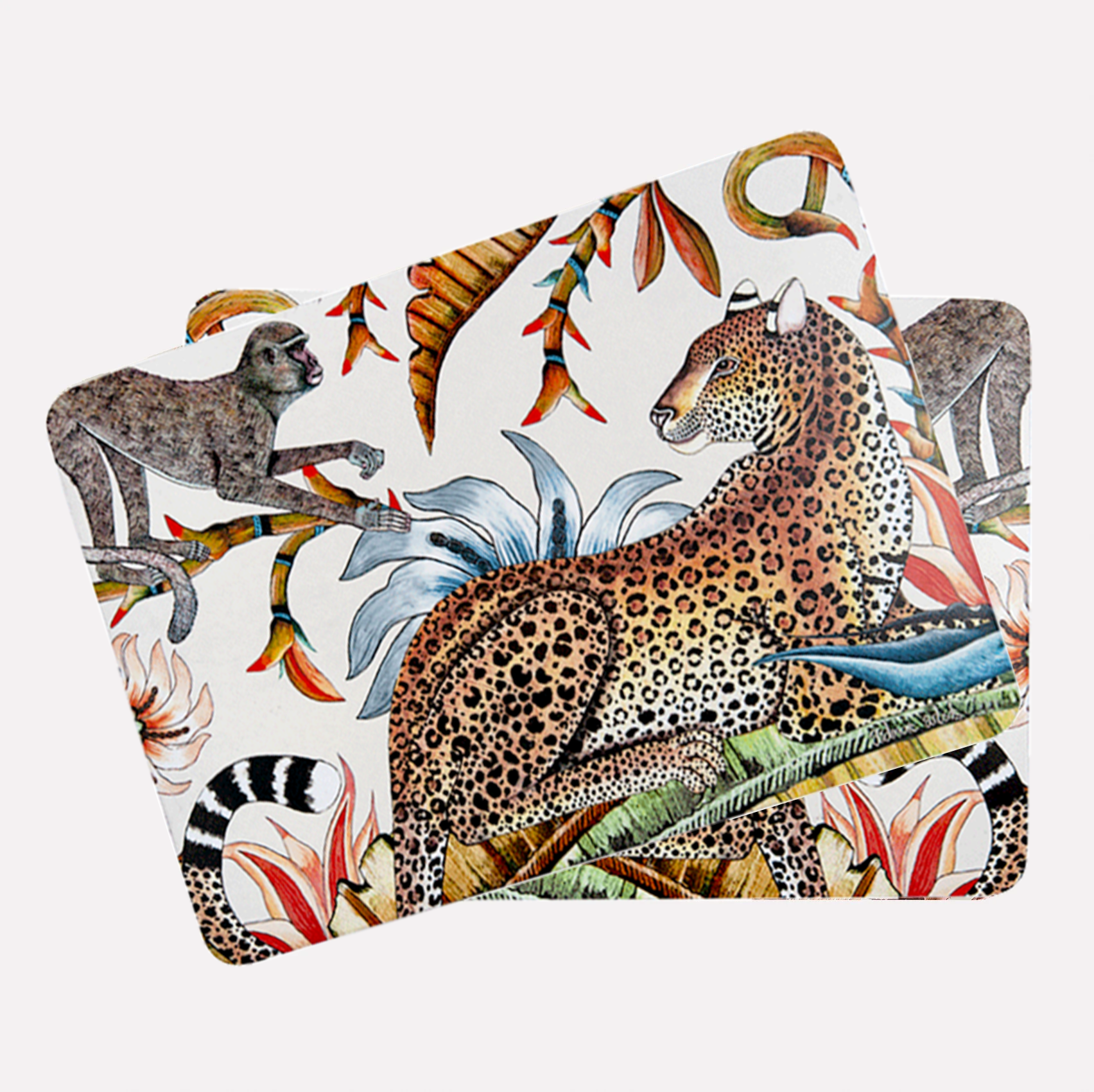 A set of placemats stacked together, showcasing the cohesive design with the leopard and monkey artfully positioned across each piece.