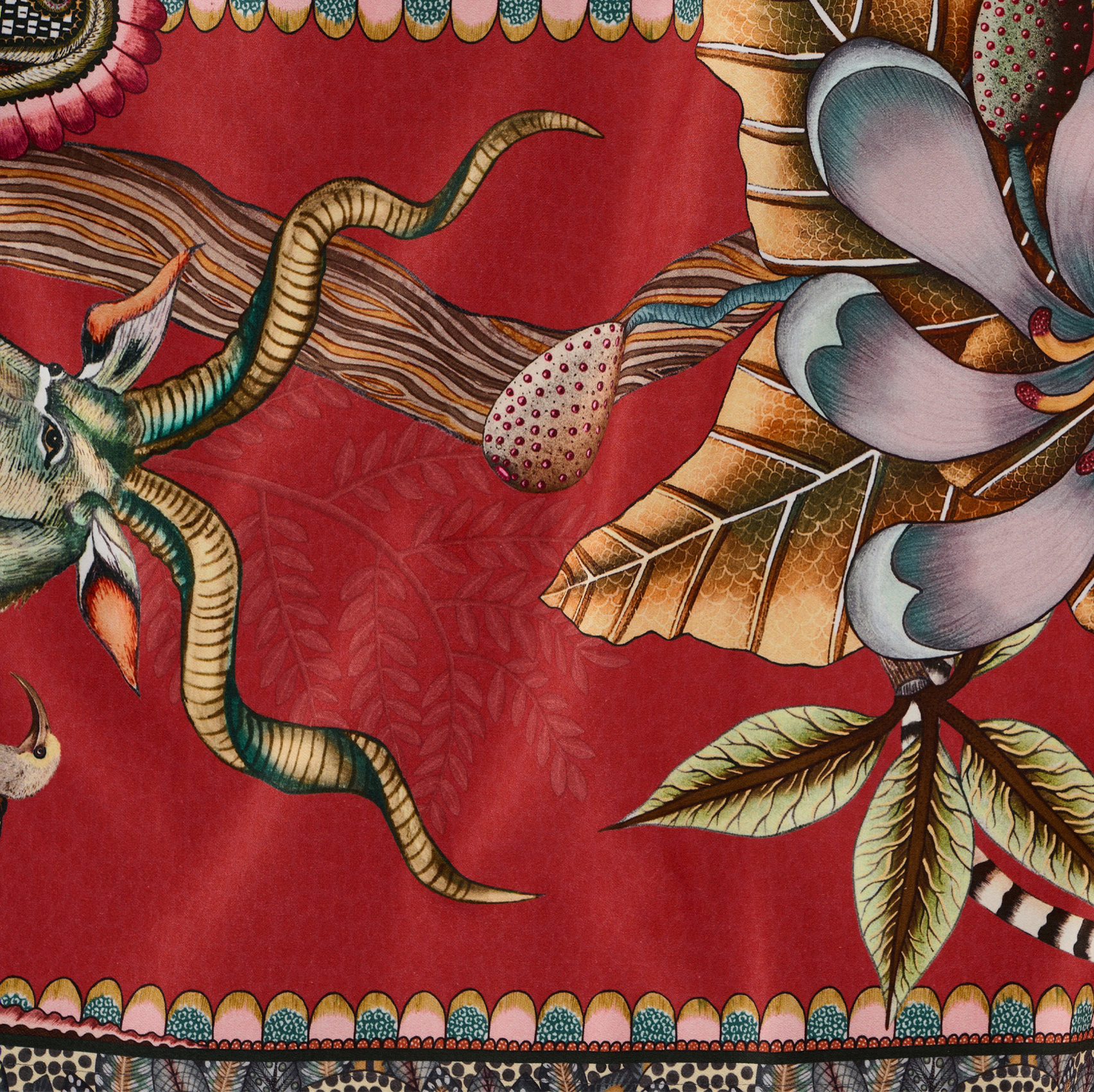 A detailed image capturing the elegance of the table runner’s artwork, featuring lush botanical elements intertwined with hidden wildlife.