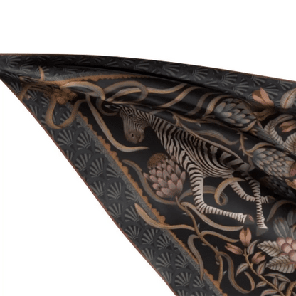 A dynamic, live flowing image showcasing the scarf’s silk texture, movement, and luxurious drape.