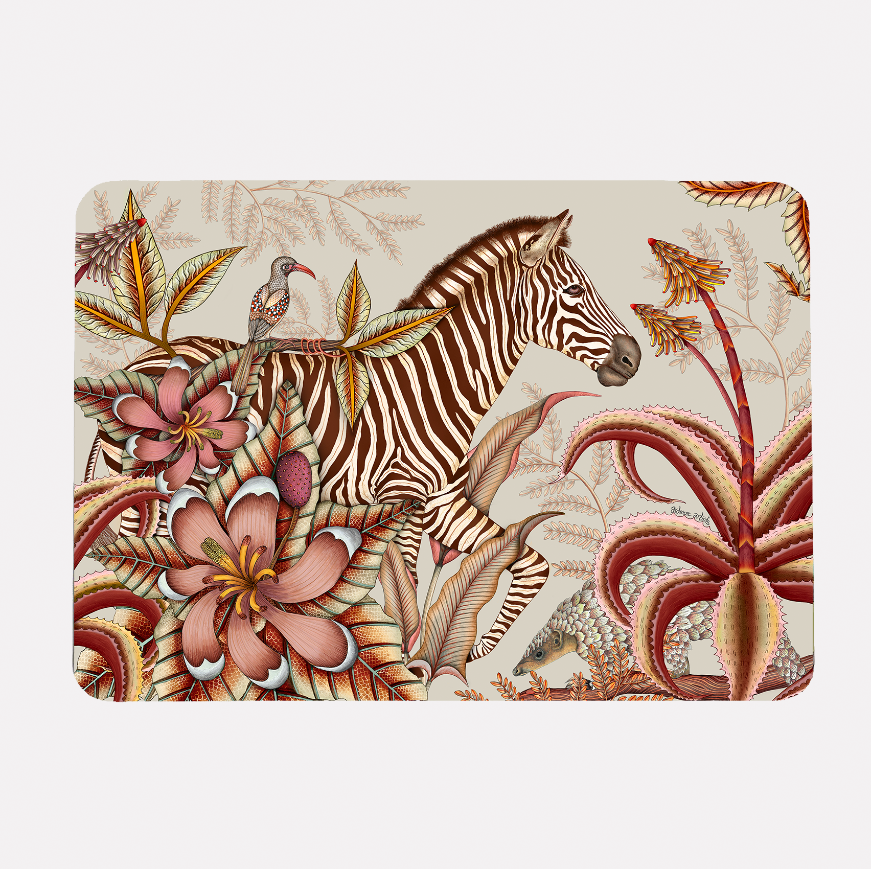 A hardboard placemat featuring a zebra surrounded by lush magnolias, flowering aloes, and intricate foliage on a soft plum background.
