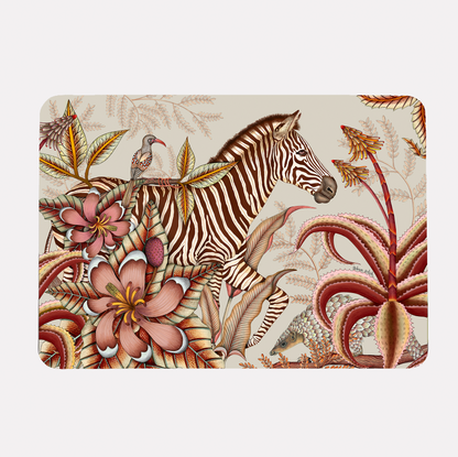A hardboard placemat featuring a zebra surrounded by lush magnolias, flowering aloes, and intricate foliage on a soft plum background.