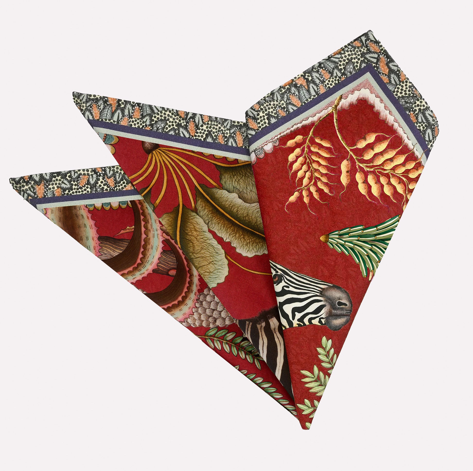 A neatly folded pair of Ardmore Thanda Stripe Napkins in Royal Red, showcasing the intricate African-inspired design with bold red tones, zebra, and floral motifs.