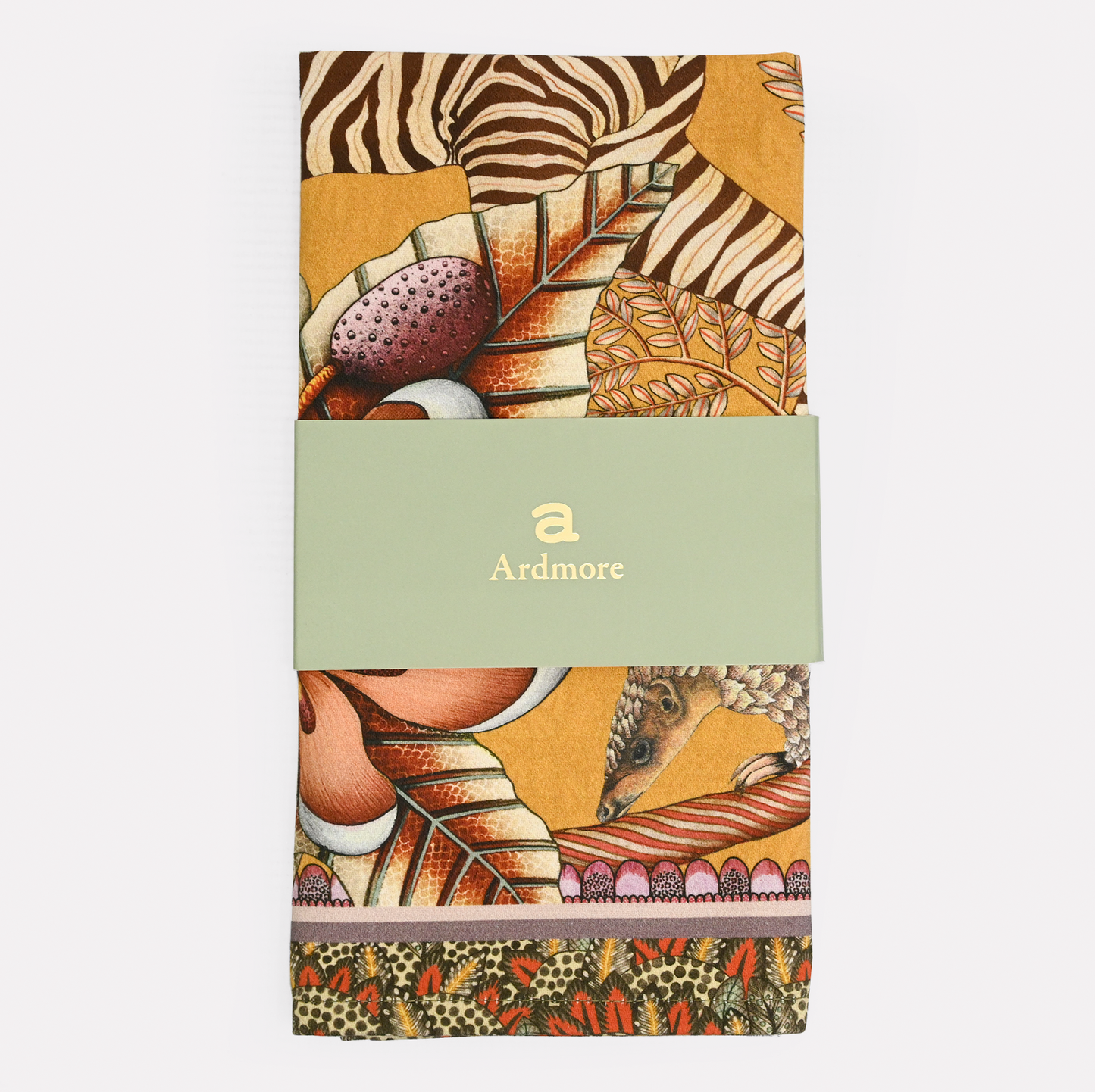 A neatly folded and packaged Ardmore Thanda Stripe Napkin in Magnolia, secured with a branded paper band, emphasizing its premium cotton fabric and exquisite design.