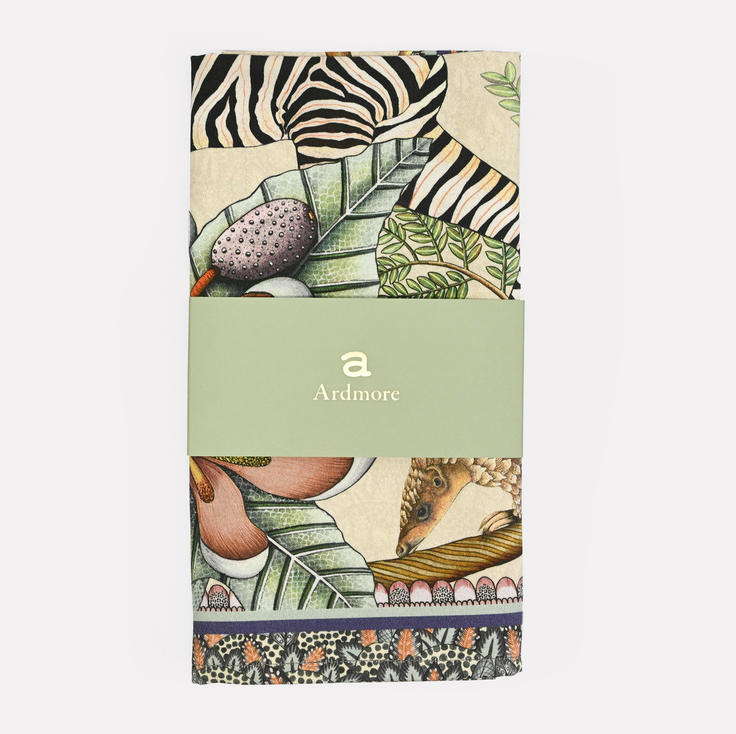 The Ardmore Thanda Stripe Napkin in Stone, neatly folded and wrapped with branded packaging, showcasing its premium quality.