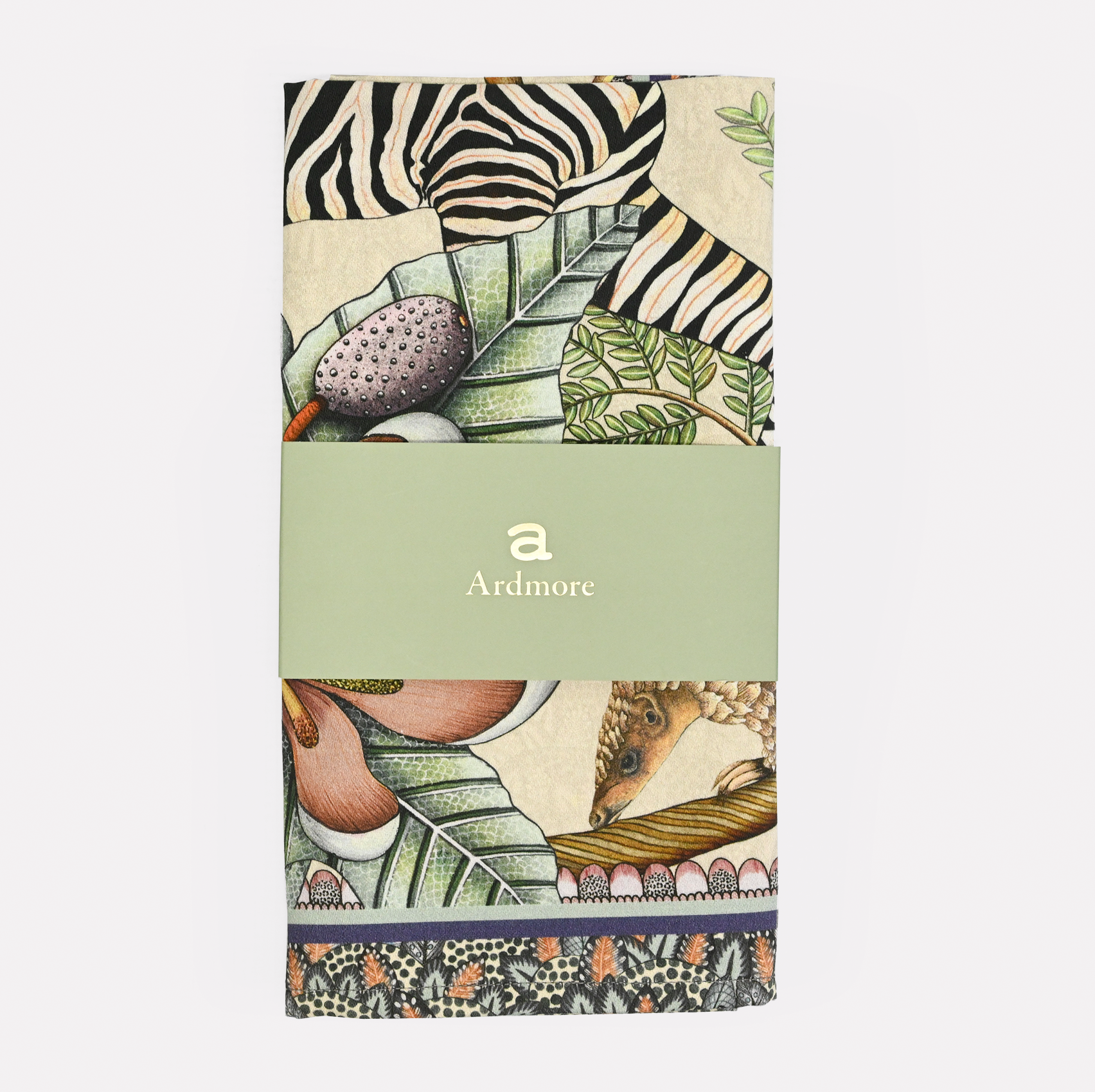 The Ardmore Thanda Stripe Napkin in Stone, neatly folded and wrapped with branded packaging, showcasing its premium quality.