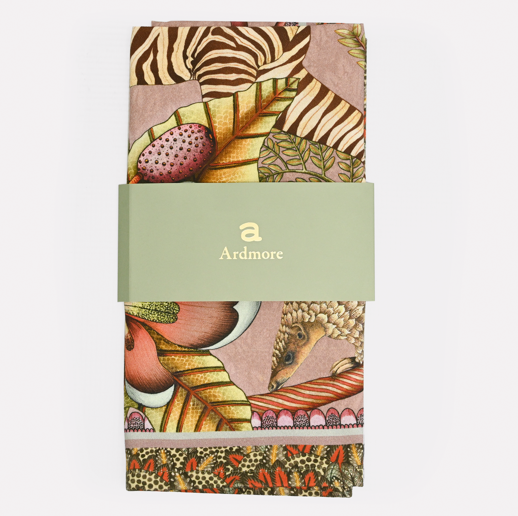 A neatly folded and packaged Ardmore Thanda Stripe Napkin in Magnolia, secured with a branded paper band, emphasizing its premium cotton fabric and exquisite craftsmanship.
