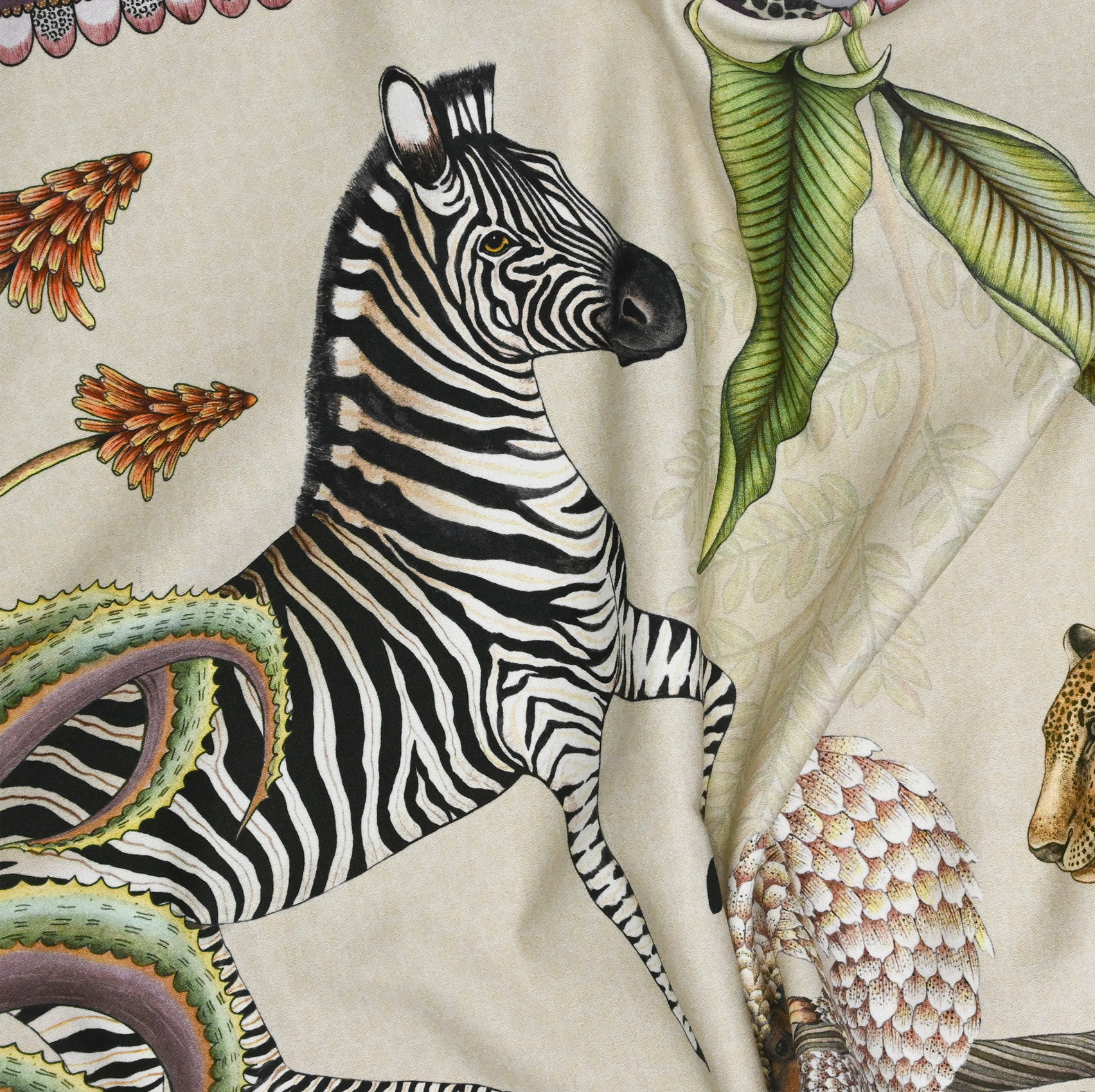 A close-up highlighting a combination of flora and fauna, including exotic plants and hidden animals in the design.