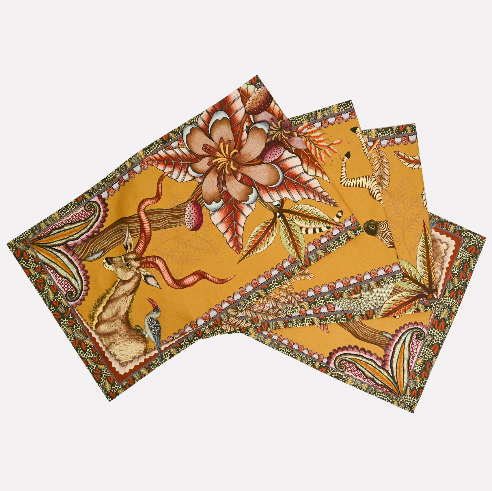 A neatly arranged set of Ardmore's Pangolin Park Table Runners in Flame, featuring a warm golden-orange background with intricate wildlife and foliage illustrations.