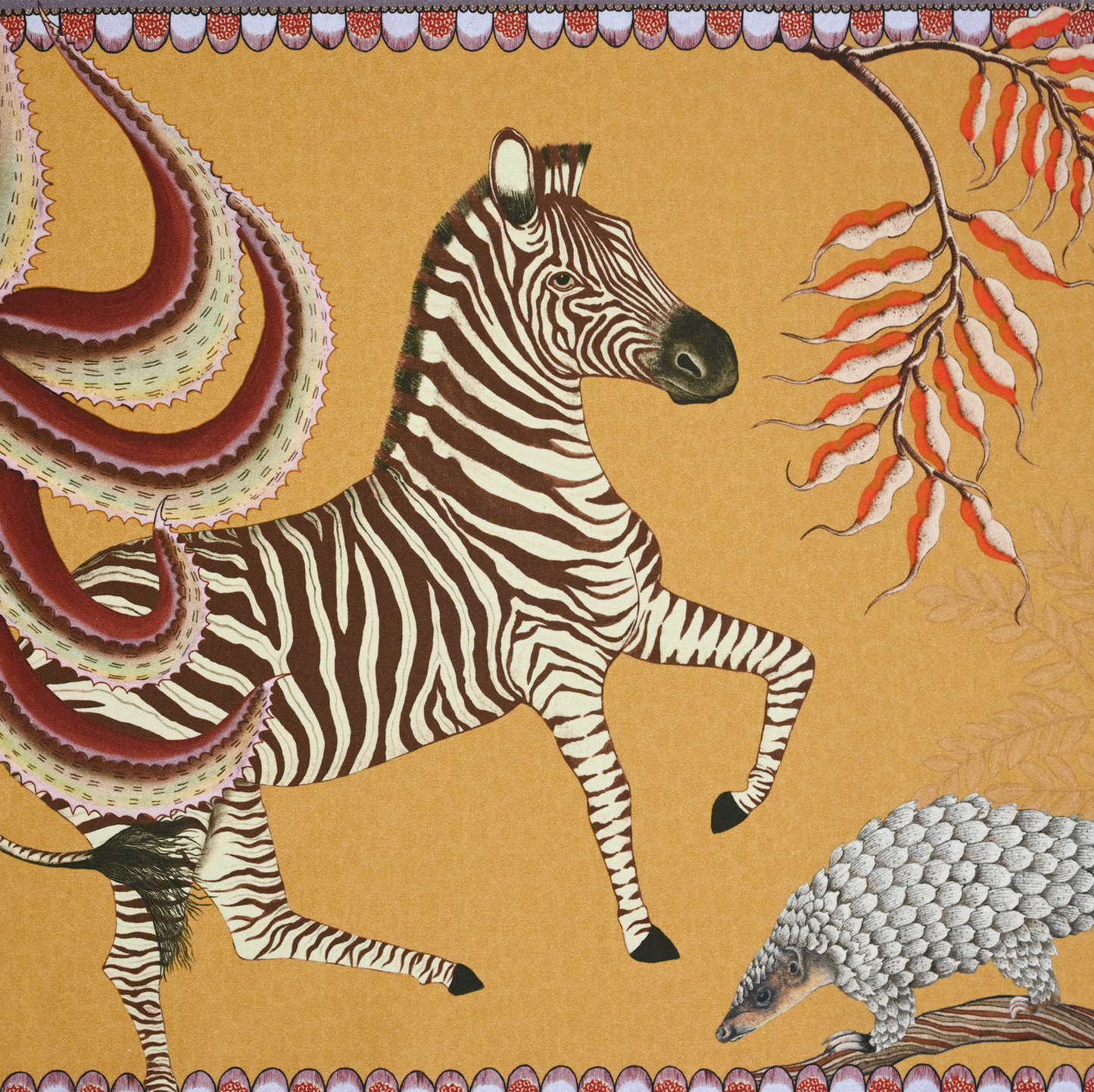 A tightly cropped shot of the table runner, focusing on a striking zebra illustration against the rich golden-orange fabric.