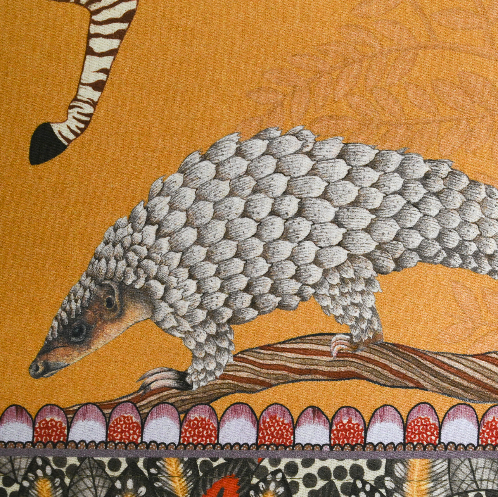 A zoomed-in image capturing the pangolin illustration woven into the fabric, highlighting the detailed artwork and earthy tones.