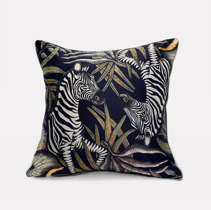 Front view of the Thanda Stripe Night Silk Cushion Cover showcasing two majestic zebras amidst lush African flora, set on a rich black silk background.
