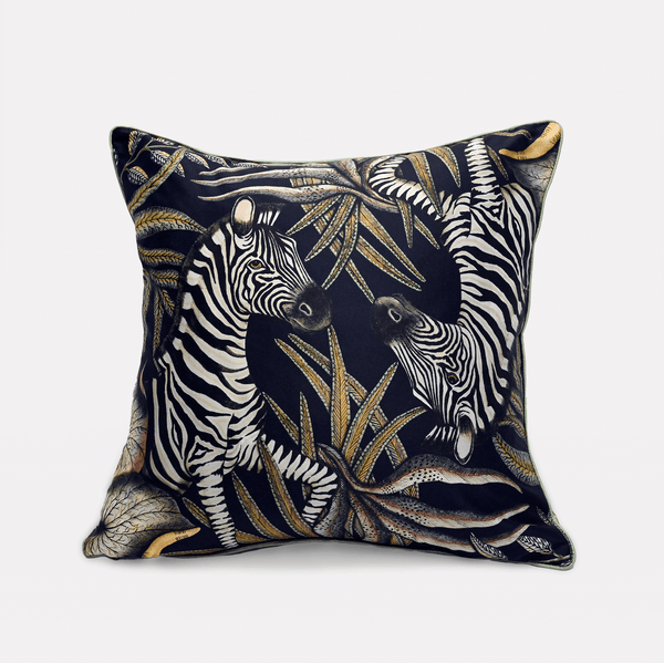 Front view of the Thanda Stripe Night Silk Cushion Cover showcasing two majestic zebras amidst lush African flora, set on a rich black silk background.