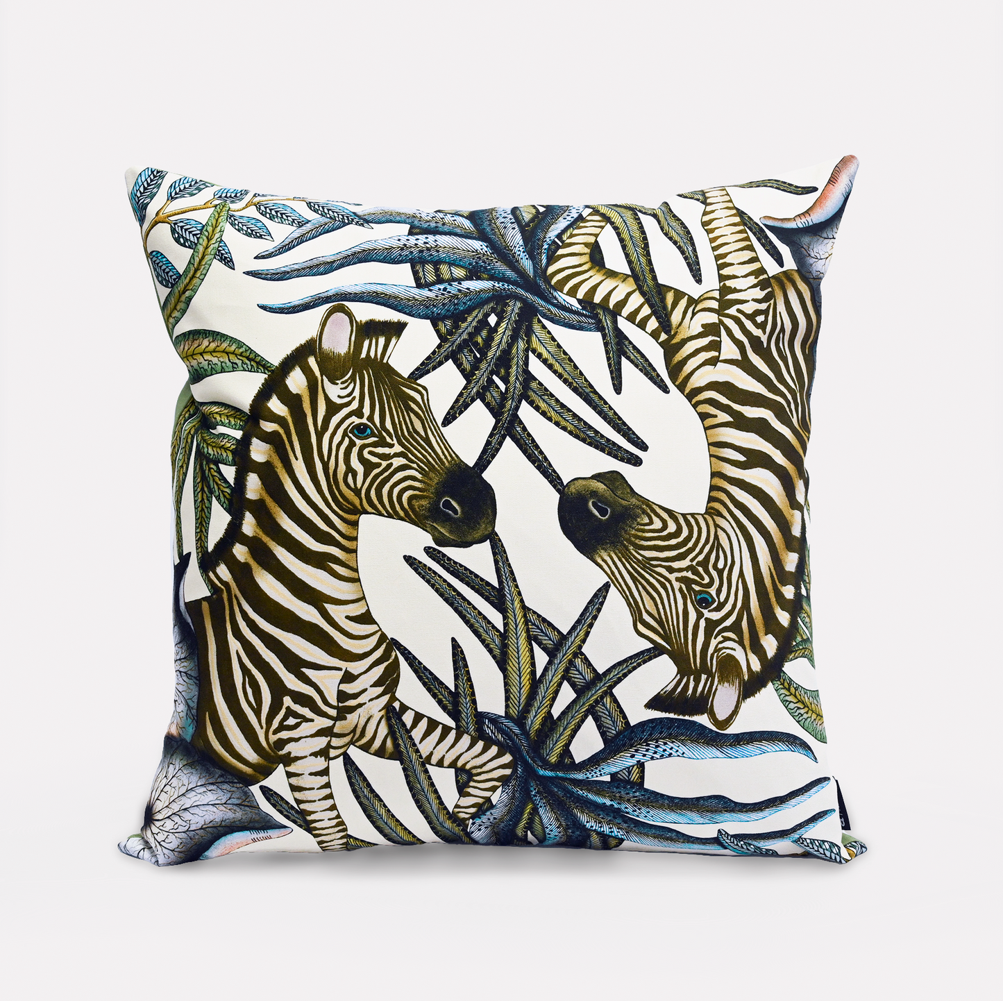 Front view of the Thanda Stripe Tanzanite Cotton Cushion Cover, showcasing a majestic zebra design surrounded by lush African flora on a soft white background, made from 100% cotton.