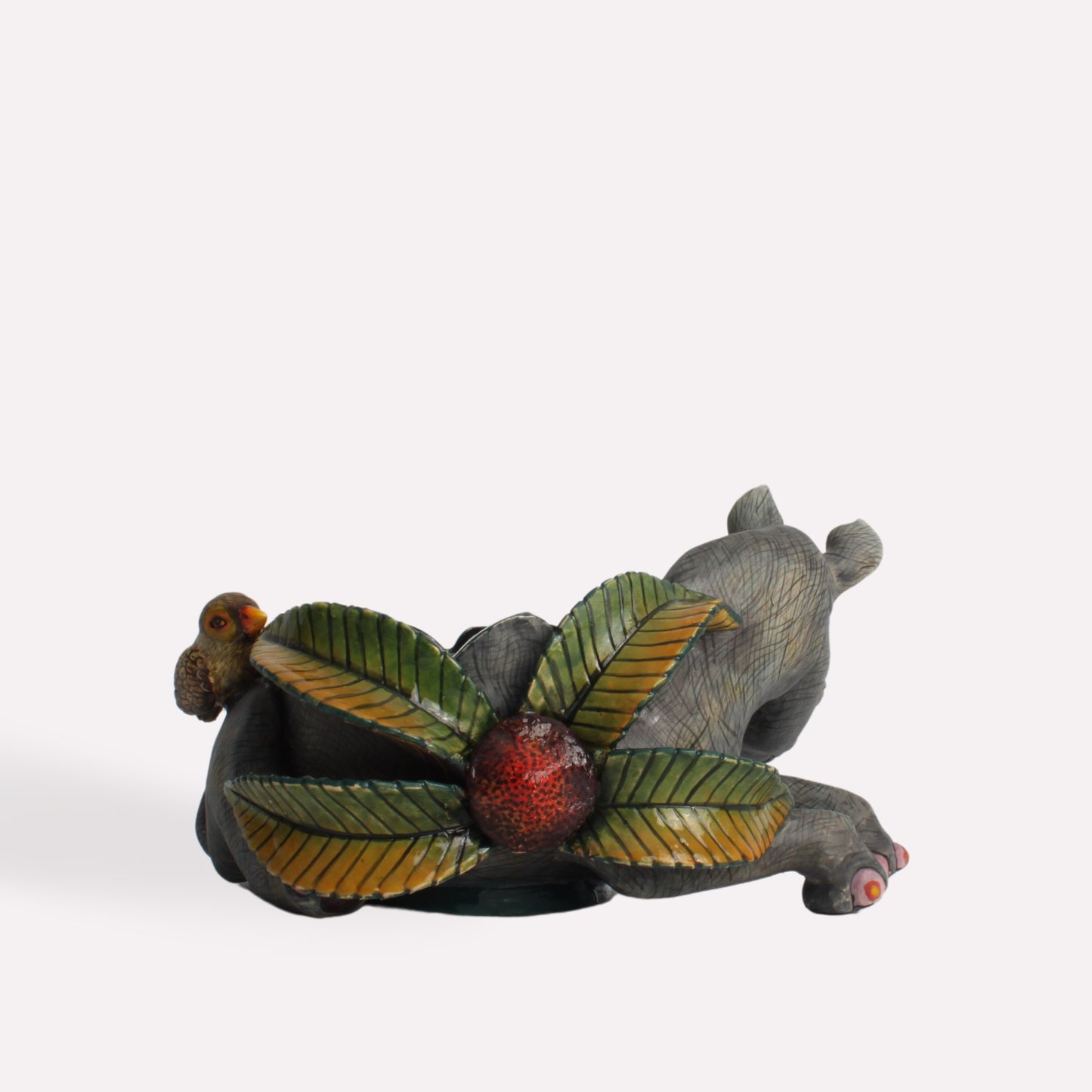  A bird’s-eye perspective showing the bowl’s interior, designed with layered leaves and organic shapes that seamlessly integrate into the rhino’s form.