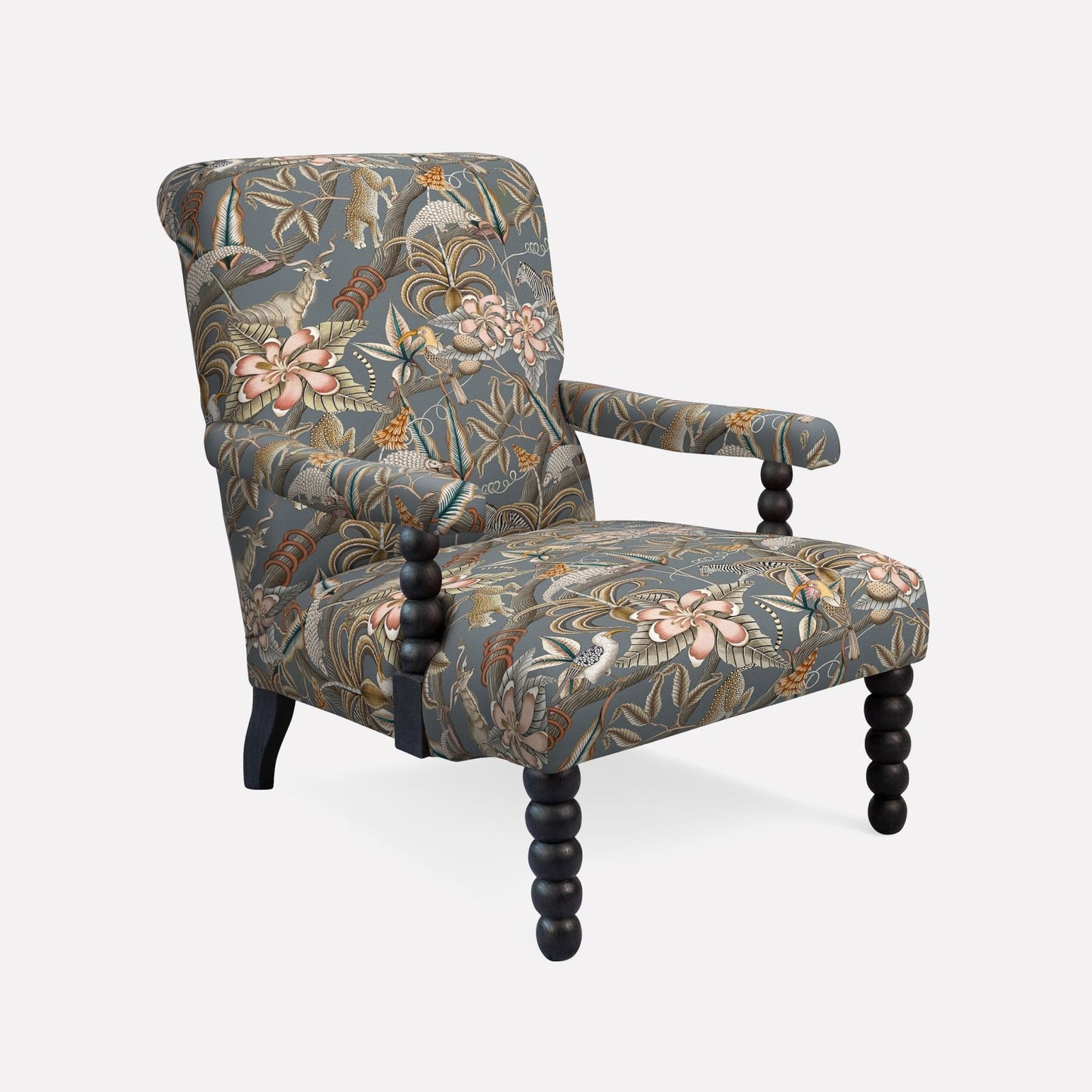 A luxurious armchair featuring a deep-toned botanical fabric with kudu and floral patterns, set on tapered oak legs.