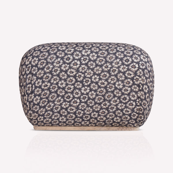 A luxurious Nyala Ottoman with a refined tortoise-shell pattern in silver and charcoal hues. The ottoman has a smooth, rounded rectangular shape, providing a plush and sophisticated seating or decorative element.