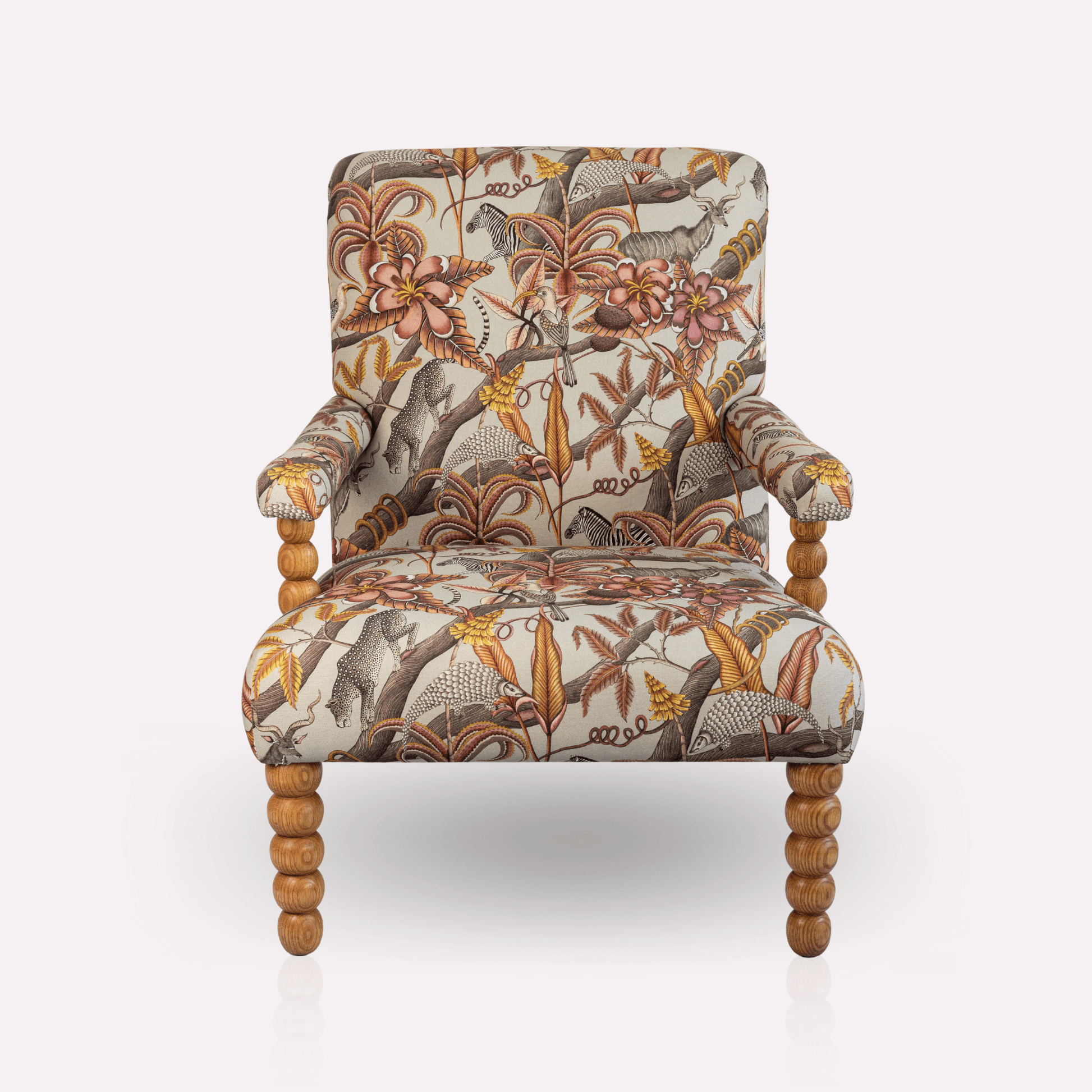 Front view of the Ardmore Kudu Pod Chair in Pangolin Plum Velvet, showcasing its high backrest, rich patterned upholstery, and sturdy oak legs