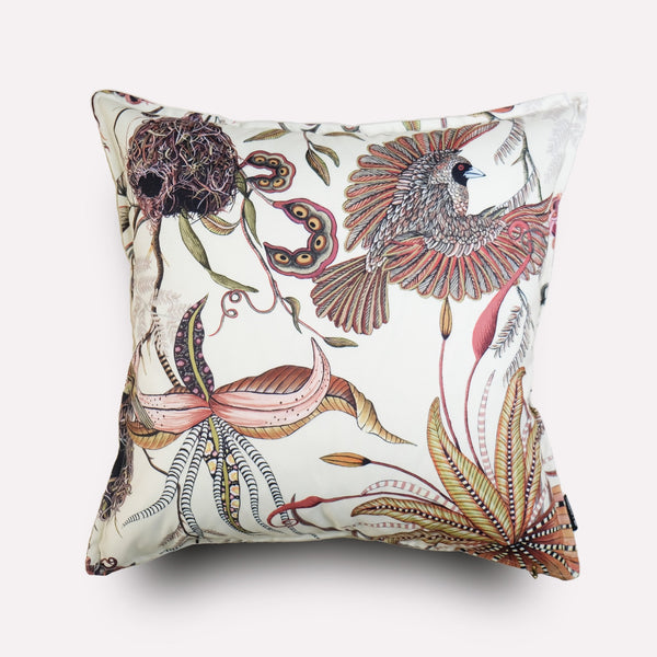 Angled view of the Thanda Nests Plum Outdoor Cushion Cover, highlighting its intricate botanical and bird-inspired patterns.